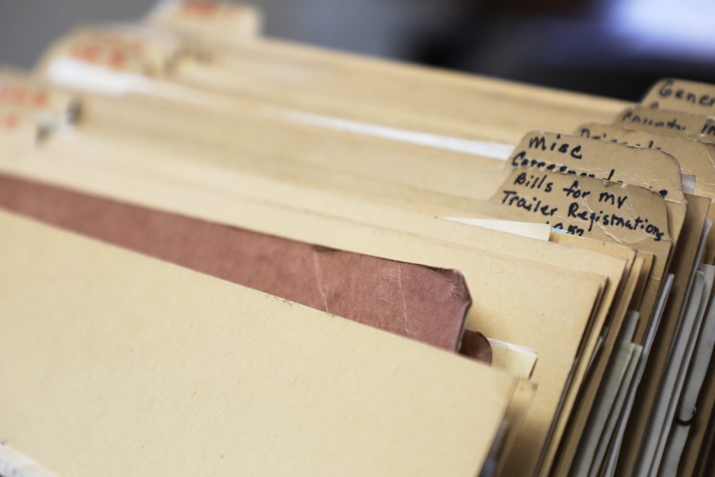 A stack of folders filled with correspondence letters from 1923 to 1976 at the Garfield County Clerk and Recorder's Office in Glenwood Springs, CO.
