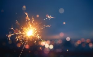 A sparkler with lights in background