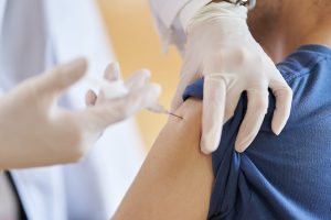 A person receives a vaccine at a long-term care facility.