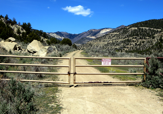 A metal gate closes off a road on Douglas Pass in far western Garfield County.