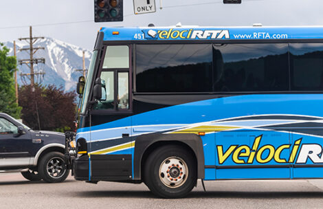 Colorado town with cars in traffic and shuttle RFTA public transportation bus.