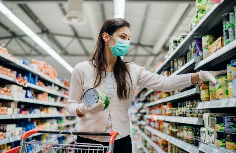 A woman shopping in a mask.