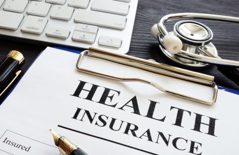 Individual health insurance policy and stethoscope.