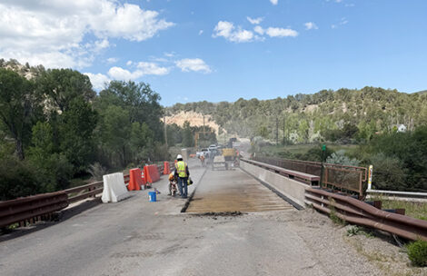 Workers prepare the County Road 108 bridge near Carbondale for new decking.