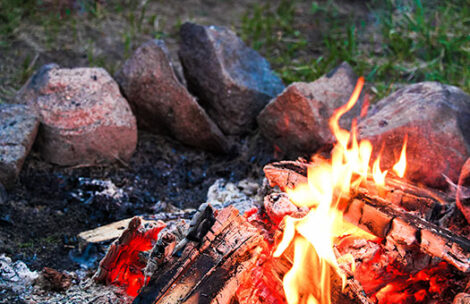 a camp fire in a rock ring