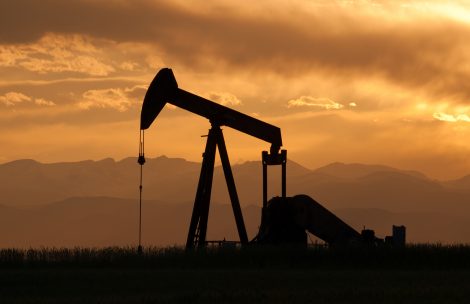 A pumpjack silhouette with dramatic sunset.