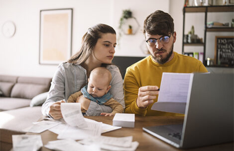 Young family with baby worried about family budget.