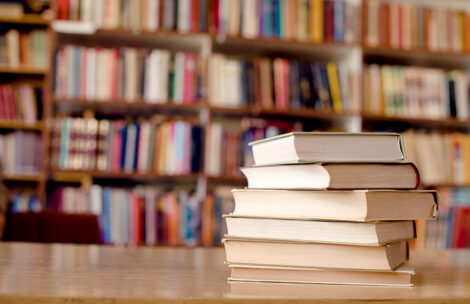 Close up of books on a desk in a library.