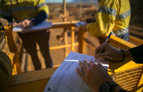 Supervisor checking building permits at new construction site.