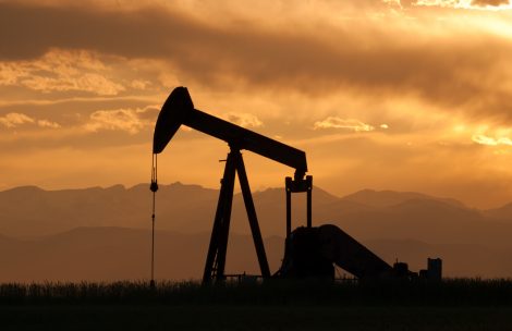 A pumpjack silhouette with dramatic sunset.