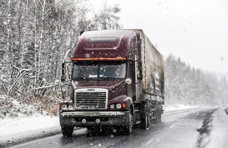 A semi driving in the snow.