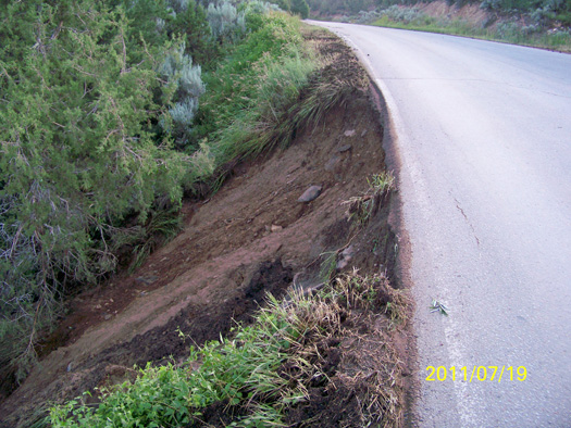 A severe thunderstorm eroded the shoulder of this section of County Road 100.