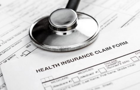 Stethoscope on health insurance claim form.