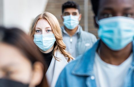 People in the city wearing face mask and commuting to work.