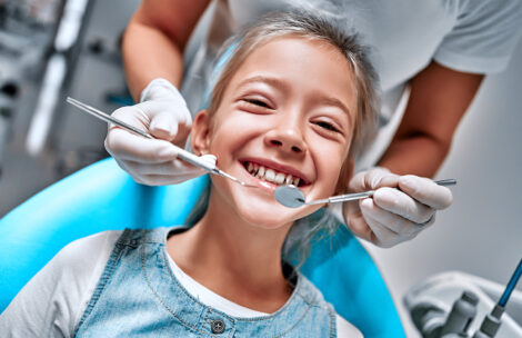 Young girl smiles at the dentist.