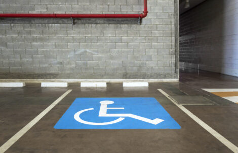Close-up of a wheelchair parking space in an indoor parking lot.