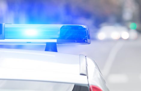 Police vehicle with lights flashing.