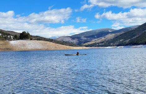A kayaker paddles across Ruedi Reservoir.