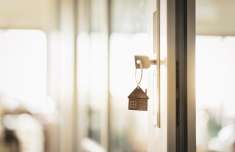 House model and key in house door. Real estate agent offer house, property insurance and security, affordable housing concepts