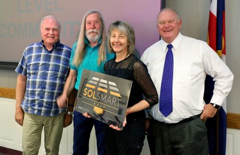 Garfield County Commissioners Tom Jankovsky, John Martin, and Mike Samson, and Community Development Director Sheryl Bower display a SolSmart Gold award.