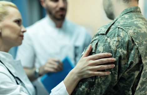 Close up of doctors consoling military officer in the hospital..
