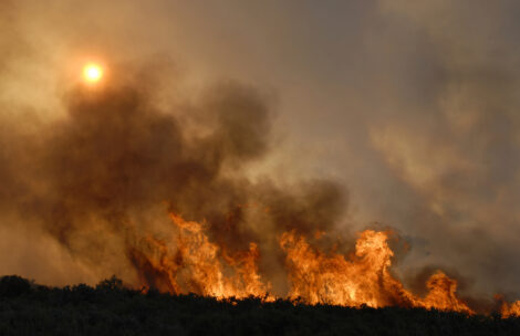 Smoke rises from a wildfire.