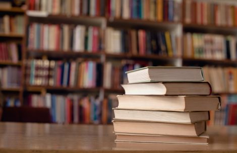 Close up of books on desk in library.
