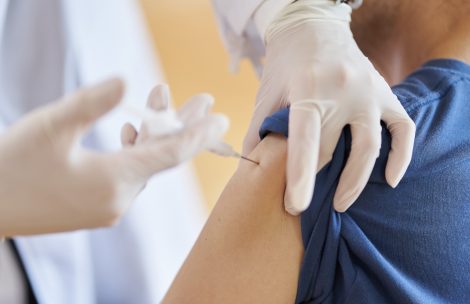 A person receives a vaccine at a long-term care facility.