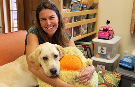 Meghan Hurley in the River Bridge Regional Center waiting room with Frasier on his first day of work. Frasier's presence will offer support to child abuse victims, more compassionately the yellow stuffed duck Hurley is holding.