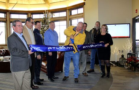 Garfield County Commissioner Mike Samson cuts a ribbon for Atlantic Aviation at the Rifle Garfield County Airport.