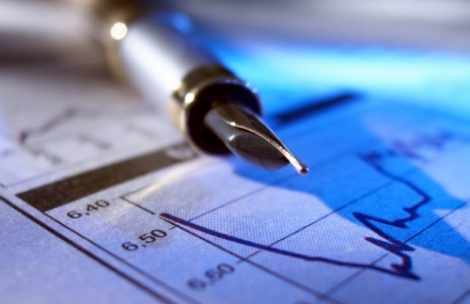 A pen on top of a finance graph.