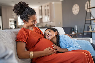 pregnent mother with daughter